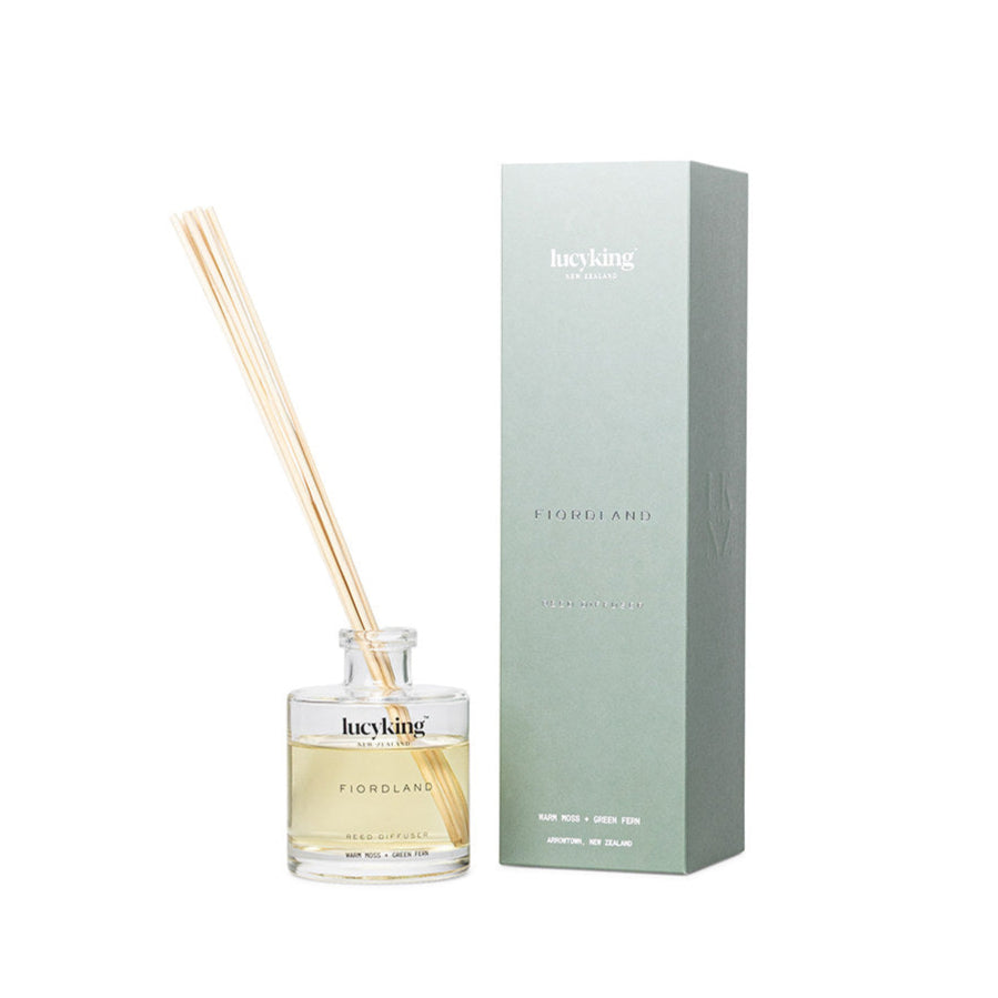 LucyKing FIORDLAND reed diffuser bottle with beige reeds and green packaging on white background