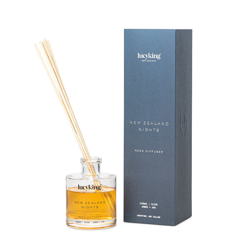 LucyKing NEW ZEALAND NIGHTS reed diffuser with clear bottle and beige reeds, blue packaging on white background