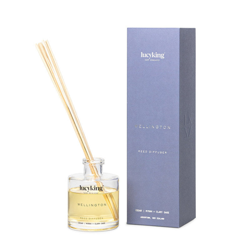 LucyKing WELLINGTON reed diffuser bottle with beige reeds and packaging on white background