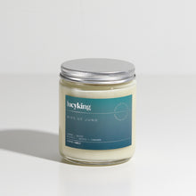 Load image into Gallery viewer, Medium signature fragrance soy wax scented candle in a clear glass jar with grey label and brushed aluminium silver screwtop lid
