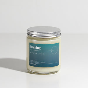 Medium signature fragrance soy wax scented candle in a clear glass jar with grey label and brushed aluminium silver screwtop lid
